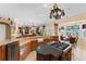 Open concept kitchen with island cooktop, breakfast bar, and modern appliances at 11715 Taylor Rd, Thonotosassa, FL 33592