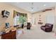 Spacious living room with large windows, cozy seating, and vintage automobile decor at 11715 Taylor Rd, Thonotosassa, FL 33592