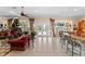 Bright living room with Christmas tree, French doors, and bar area with counter seating at 11715 Taylor Rd, Thonotosassa, FL 33592