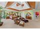 Spacious main bedroom with a tray ceiling, ceiling fan, sitting area, and an ensuite bathroom at 11715 Taylor Rd, Thonotosassa, FL 33592