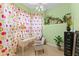 Bright home office featuring a neutral chair, desk, colorful curtains, and shelving with multiple potted plants at 11715 Taylor Rd, Thonotosassa, FL 33592