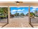 Covered patio with pillars, showcasing a serene view of the pool and waterfront at 11715 Taylor Rd, Thonotosassa, FL 33592