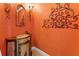 Elegant powder room featuring bright walls, decorative mirror, and unique vanity at 11715 Taylor Rd, Thonotosassa, FL 33592