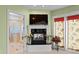 Relaxing sitting area with fireplace, TV, and access to the bathroom with glass block shower at 11715 Taylor Rd, Thonotosassa, FL 33592