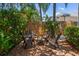 Secluded backyard seating area with a firepit, surrounded by lush foliage and a privacy fence at 11910 Keating Dr, Tampa, FL 33626