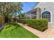 Well-maintained backyard with lush landscaping, privacy hedges, and a screened-in patio at 11910 Keating Dr, Tampa, FL 33626