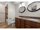 Spacious bathroom featuring a double vanity with granite countertops and a tiled shower at 11910 Keating Dr, Tampa, FL 33626