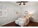 Cozy bedroom with a ceiling fan, a bed, fluffy stools and decor at 11910 Keating Dr, Tampa, FL 33626