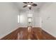 Spacious bedroom featuring hardwood floors, white trim, and a ceiling fan at 11910 Keating Dr, Tampa, FL 33626