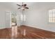 Large bedroom with wood floors, a ceiling fan, and access to a screened outdoor space at 11910 Keating Dr, Tampa, FL 33626
