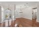Bright foyer featuring hardwood floors, a decorative chandelier, and arched windows at 11910 Keating Dr, Tampa, FL 33626