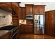 Well-equipped kitchen featuring stainless steel appliances, wood cabinetry, and a tile backsplash at 11910 Keating Dr, Tampa, FL 33626