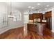 Open kitchen with central island, granite countertops, wood cabinetry and stainless appliances at 11910 Keating Dr, Tampa, FL 33626