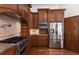 Gourmet kitchen featuring stainless steel appliances and custom wood cabinets at 11910 Keating Dr, Tampa, FL 33626