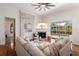 Comfortable living room with fireplace, stone accent wall, sliding glass door and a view of the pool at 11910 Keating Dr, Tampa, FL 33626