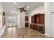 Open living room with built-in cabinets, wine coolers and access to outdoor pool area at 11910 Keating Dr, Tampa, FL 33626