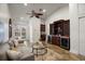 Relaxing living room with built-in bar area, wine coolers, comfortable seating, and outdoor access at 11910 Keating Dr, Tampa, FL 33626