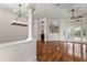 Open-concept living area boasts hardwood floors, a decorative chandelier, and archways at 11910 Keating Dr, Tampa, FL 33626
