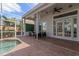Covered patio with outdoor seating area, ceiling fans, and pool access at 11910 Keating Dr, Tampa, FL 33626