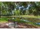 Community pond with park bench, water feature and mature trees at 11910 Keating Dr, Tampa, FL 33626