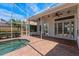 Covered patio with brick pavers featuring a screened-in pool and tropical landscaping at 11910 Keating Dr, Tampa, FL 33626