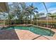 Screened-in pool and spa area with brick pavers and tropical landscaping at 11910 Keating Dr, Tampa, FL 33626