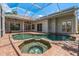 Screened-in pool and spa area with brick pavers and multiple seating areas at 11910 Keating Dr, Tampa, FL 33626