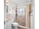 Tiled bathroom with modern toilet and sink, with a shower with curtain in the background at 12400 Park Blvd # 522, Seminole, FL 33772