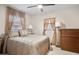 Comfortable bedroom featuring neutral tones, natural light, and fan at 12400 Park Blvd # 522, Seminole, FL 33772