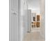 Hallway with plentiful storage with white cabinets and access to the kitchen and other rooms at 12400 Park Blvd # 522, Seminole, FL 33772