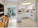 Bright kitchen with white cabinetry, modern appliances, and sliding glass doors to the outdoor patio at 12400 Park Blvd # 522, Seminole, FL 33772