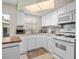 Well-equipped kitchen with white cabinets, modern appliances, and ample counter space for cooking at 12400 Park Blvd # 522, Seminole, FL 33772