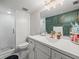 Stylish bathroom with a modern vanity, a walk-in shower with glass doors, and elegant decor at 129 Cypress Ct, Oldsmar, FL 34677