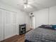 Bedroom featuring a ceiling fan, laminate flooring, access to closet, and an adjacent bathroom at 129 Cypress Ct, Oldsmar, FL 34677