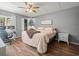Comfortable bedroom with a ceiling fan, desk, closet, and view of the window with natural light at 129 Cypress Ct, Oldsmar, FL 34677