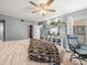 Relaxing bedroom with a ceiling fan, closet, natural light, and easy access to a bathroom at 129 Cypress Ct, Oldsmar, FL 34677