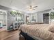 Sun-filled bedroom featuring wood-look floors and a decorative plant shelf for a fresh aesthetic at 129 Cypress Ct, Oldsmar, FL 34677