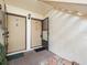 Open front entrance featuring unit door with security door and decorative rock landscaping at 129 Cypress Ct, Oldsmar, FL 34677