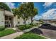 Well-maintained condo building featuring assigned covered parking and lush landscaping at 129 Cypress Ct, Oldsmar, FL 34677