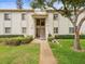 Inviting condo featuring a well-manicured lawn and sidewalk leading to the front entry at 129 Cypress Ct, Oldsmar, FL 34677