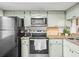 Efficient kitchen featuring modern appliances, a bright window, and ample counter space at 129 Cypress Ct, Oldsmar, FL 34677