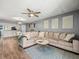 Relaxing living room with a comfortable sectional sofa and an open view of the adjacent kitchen at 129 Cypress Ct, Oldsmar, FL 34677