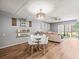 Living room with wood-look floors, gray walls, modern furniture, and lots of sunlight at 129 Cypress Ct, Oldsmar, FL 34677