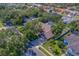 Aerial view of a residential neighborhood, displaying houses with pools, mature trees, and neat landscaping at 14073 Jennifer Ter, Largo, FL 33774