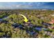 Scenic aerial shot of a peaceful community surrounded by mature trees, complemented by a serene lake and coastal views at 14073 Jennifer Ter, Largo, FL 33774