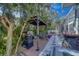 Backyard with a screened-in pool, tropical landscaping, and a cozy gazebo with grill at 14073 Jennifer Ter, Largo, FL 33774