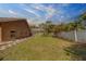 Green backyard featuring a screened in patio and neatly landscaped flower beds at 14073 Jennifer Ter, Largo, FL 33774