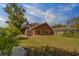 Backyard showcasing lush lawn, a shed, and screened-in lanai offering an ideal outdoor retreat at 14073 Jennifer Ter, Largo, FL 33774