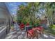Tropical backyard showcasing a cozy seating area with chairs around a fire pit at 14073 Jennifer Ter, Largo, FL 33774