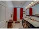 Cozy bathroom featuring vanity, toilet, and shower with red curtains with tile backsplash at 14073 Jennifer Ter, Largo, FL 33774